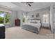Bright main bedroom with neutral carpet, ceiling fan, and large windows at 2925 Westfield Rd, Charlotte, NC 28209