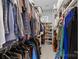 Spacious walk-in closet featuring ample hanging space and built-in shelving for shoe storage at 2925 Westfield Rd, Charlotte, NC 28209