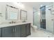 New bathroom with double sinks, quartz countertop, framed mirrors, and glass enclosed shower at 322 S Hill St, Gastonia, NC 28052