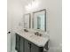 Bright bathroom featuring double sink, quartz countertop, framed mirrors, and modern fixtures at 322 S Hill St, Gastonia, NC 28052