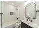 Updated bathroom features modern fixtures, subway tile in shower, and black-and-white patterned floor at 322 S Hill St, Gastonia, NC 28052