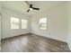 Bright bedroom with ceiling fan and natural light streaming through multiple windows at 322 S Hill St, Gastonia, NC 28052