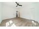 Bright bedroom features luxury vinyl plank flooring, a ceiling fan, and neutral walls at 322 S Hill St, Gastonia, NC 28052