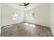 Sunlit bedroom featuring modern ceiling fan and bright windows at 322 S Hill St, Gastonia, NC 28052