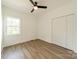 Clean bedroom with ceiling fan, spacious closet, and ample natural light at 322 S Hill St, Gastonia, NC 28052