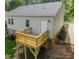 Exterior of a lovely home featuring a deck, vinyl siding, and brick foundation at 322 S Hill St, Gastonia, NC 28052