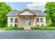 Charming home with light siding, covered front porch, and well-manicured lawn at 322 S Hill St, Gastonia, NC 28052