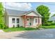 Charming home with light siding, covered front porch, and well-manicured lawn at 322 S Hill St, Gastonia, NC 28052