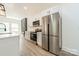Modern kitchen with white cabinets, stainless steel appliances, and center island at 322 S Hill St, Gastonia, NC 28052