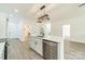 Modern kitchen with island, stainless steel dishwasher, updated lighting, and stylish finishes at 322 S Hill St, Gastonia, NC 28052