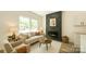 Bright living room featuring wood-look flooring and a modern fireplace accent wall at 322 S Hill St, Gastonia, NC 28052