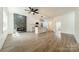 Open-concept living space showcasing a modern fireplace and a bright kitchen area at 322 S Hill St, Gastonia, NC 28052