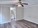 Cozy bedroom featuring a ceiling fan, wood-look floors, and an ensuite bathroom at 341 Austin Dr, York, SC 29745