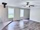 Spacious living room with wood-look flooring, large windows, and fireplace, creating a comfortable space at 341 Austin Dr, York, SC 29745