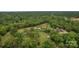 Expansive aerial view of a private estate with a beautiful home surrounded by lush greenery and mature trees at 3440 17Th Ne Ave, Hickory, NC 28601