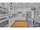 Well-lit kitchen with white cabinets, stainless steel appliances, granite countertops, and hardwood floors at 3440 17Th Ne Ave, Hickory, NC 28601