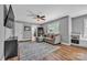 Cozy living room featuring a comfortable sectional couch, ceiling fan, window, and hardwood floors at 3440 17Th Ne Ave, Hickory, NC 28601