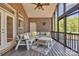 Comfortable screened porch with wicker seating, decorative pillows, ceiling fan and brick siding at 3440 17Th Ne Ave, Hickory, NC 28601
