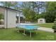 Backyard featuring a pool and a ping pong table on a well-manicured lawn at 400 Hunter Ln, Charlotte, NC 28211