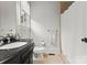Clean bathroom features a modern vanity with a granite countertop, a toilet, and shower at 400 Hunter Ln, Charlotte, NC 28211