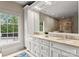Bathroom with a large mirror over double sinks and bright window light at 400 Hunter Ln, Charlotte, NC 28211