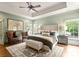 Spacious main bedroom with a sitting area, tray ceiling, and large windows at 400 Hunter Ln, Charlotte, NC 28211