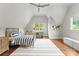 Bedroom with hardwood floors, blue and white striped bedding, large windows, and desk at 400 Hunter Ln, Charlotte, NC 28211