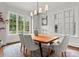 Formal dining room features a wood table, upholstered chairs, and large windows at 400 Hunter Ln, Charlotte, NC 28211