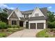 Beautiful two-story home boasts stone accents, a two-car garage, and a well-manicured lawn at 400 Hunter Ln, Charlotte, NC 28211