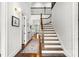 Bright foyer with hardwood floors, staircase, and wrought iron railing at 400 Hunter Ln, Charlotte, NC 28211