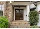 Elegant front entrance features a stone facade, double doors, and stone steps at 400 Hunter Ln, Charlotte, NC 28211