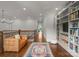 Hallway features wood floors, leather couch, rug, and built-in bookcase at 400 Hunter Ln, Charlotte, NC 28211