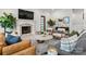 Bright living room features fireplace with TV, modern furniture, accent rug and stylish decor at 400 Hunter Ln, Charlotte, NC 28211