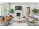 Bright living room boasts a fireplace with TV, modern furniture, and large windows at 400 Hunter Ln, Charlotte, NC 28211