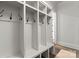 Clean mudroom features a built-in storage unit with hooks and cubbies, and tile flooring at 400 Hunter Ln, Charlotte, NC 28211