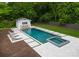 Pool and jacuzzi with a backdrop of green landscaping and a cabana at 400 Hunter Ln, Charlotte, NC 28211