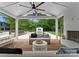 Open porch with ceiling fan featuring a fireplace, outdoor furniture, and view of the pool at 400 Hunter Ln, Charlotte, NC 28211