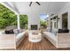 Covered porch featuring white brick fireplace, ceiling fan and wicker sofas with throw pillows at 400 Hunter Ln, Charlotte, NC 28211
