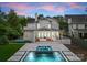 Rear exterior featuring a covered porch, a swimming pool and manicured lawn at 400 Hunter Ln, Charlotte, NC 28211