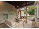 Screened porch with a ceiling fan, an outside view, wicker sofas, and a fireplace at 400 Hunter Ln, Charlotte, NC 28211