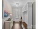 Inviting foyer with dark wood floors, built-in storage, decorative art, and a well-lit entrance at 4030 City Homes Pl, Charlotte, NC 28209