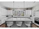 Spacious kitchen with white cabinets, marble countertops, and pendant lighting at 4030 City Homes Pl, Charlotte, NC 28209