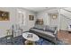 Cozy living space featuring a grey sofa, striped chair, and a white oval coffee table on a blue patterned rug at 4030 City Homes Pl, Charlotte, NC 28209
