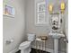 Elegant powder room with pedestal sink, decorative lighting, and stylish accents at 4030 City Homes Pl, Charlotte, NC 28209