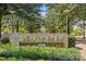 Community sign surrounded by lush landscaping, creating an inviting entrance at 4030 City Homes Pl, Charlotte, NC 28209