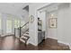 Inviting entry hall with staircase, hardwood floors, and a convenient beverage station with mini-fridge at 4030 City Homes Pl, Charlotte, NC 28209