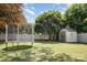 Expansive backyard featuring lush green grass, trampoline, swing set, and storage shed at 4100 Sudbury Rd, Charlotte, NC 28205
