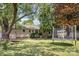 A backyard featuring mature trees, a porch swing, and a trampoline at 4100 Sudbury Rd, Charlotte, NC 28205