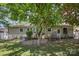 A backyard featuring mature trees, a porch swing, and a garden at 4100 Sudbury Rd, Charlotte, NC 28205