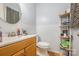 A full bathroom featuring a wood vanity and white wainscoting at 4100 Sudbury Rd, Charlotte, NC 28205